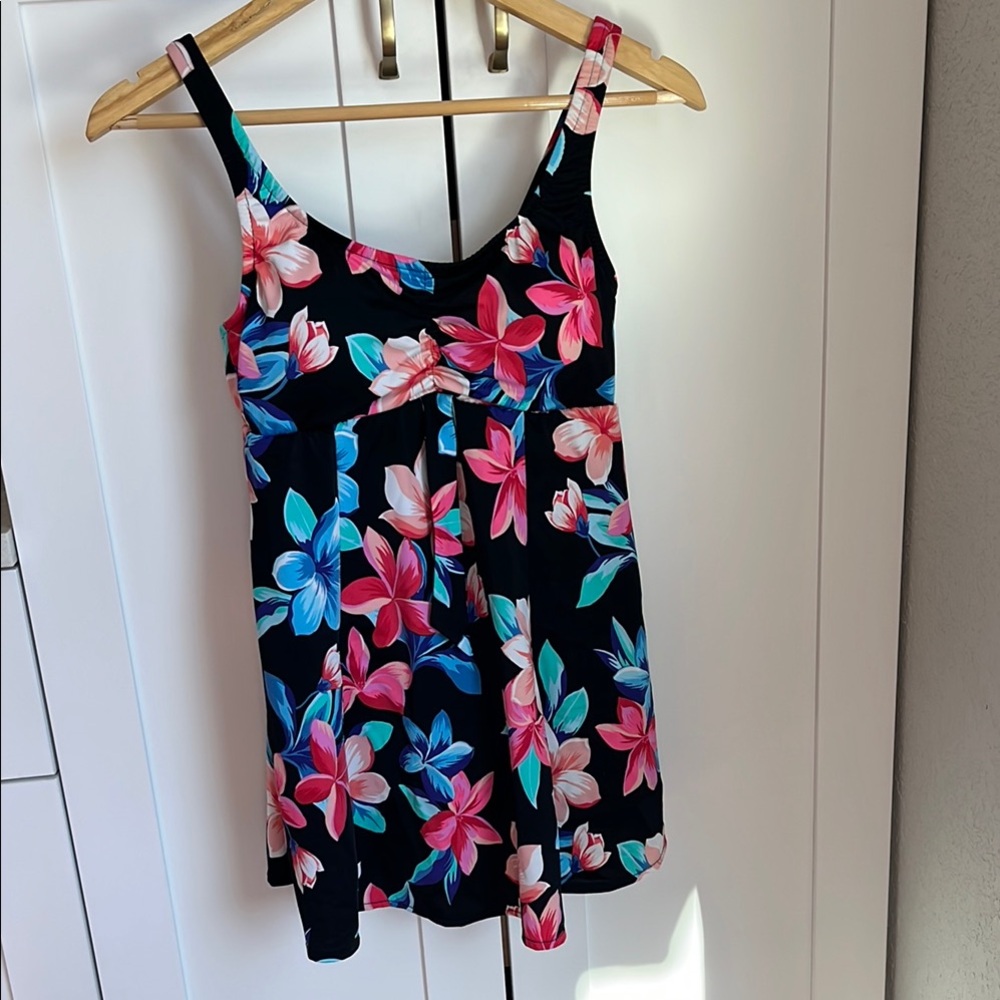 Vibrant floral one piece swim suit with dress like silhouette.